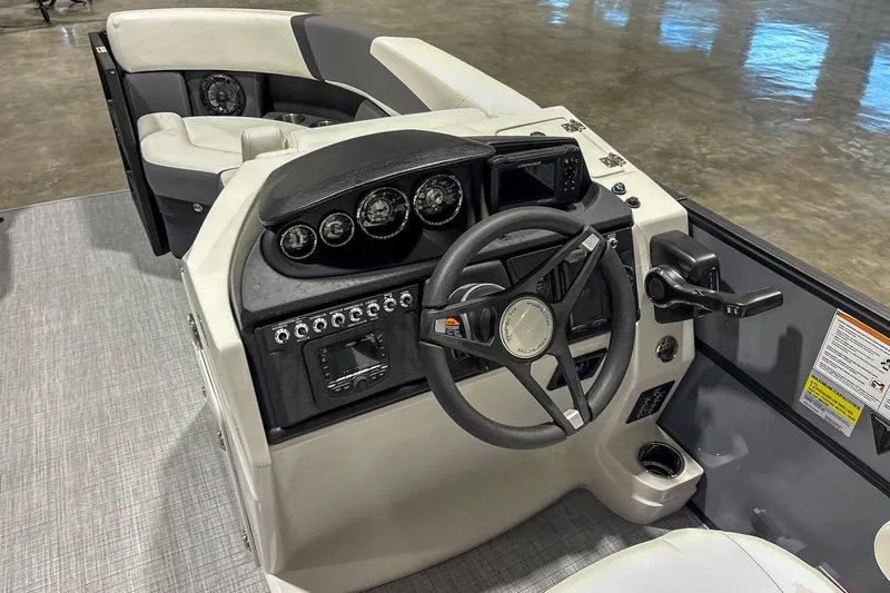 Slide: The Image of 2025 Trifecta 22RF CS boat dashboard with steering wheel and control panel. - 11