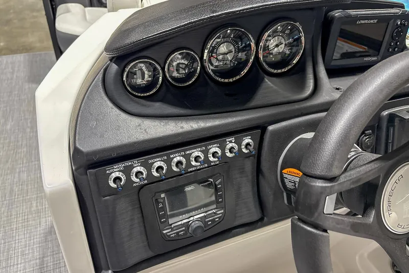 Slide: The Image of 2025 Trifecta 22RF CS dashboard with gauges, switches, and steering wheel. - 9