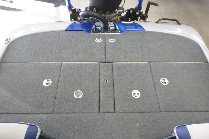 Slide: The Image of 2020 Skeeter FXR21 boat deck with gray carpet and storage compartments. - 17