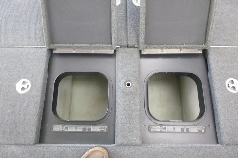 Slide: The Image of 2020 Skeeter FXR21 boat storage compartments with open lids, showcasing interior space. - 18