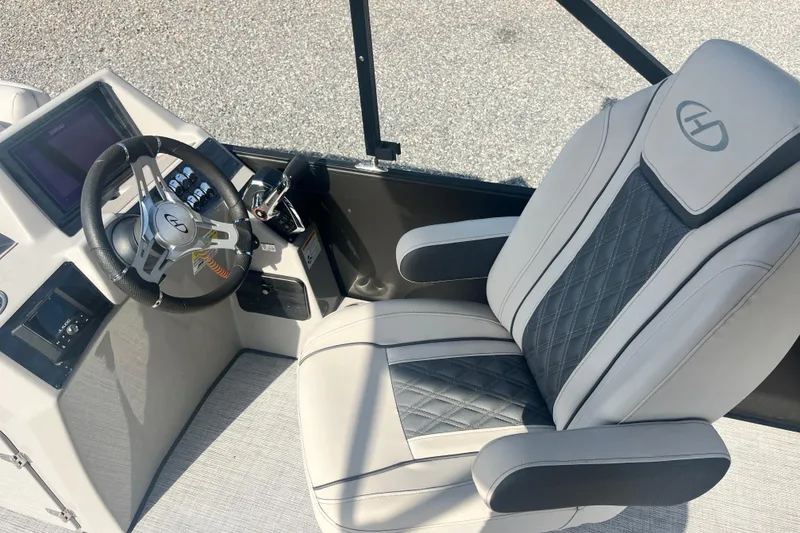 Slide: The Image of 2023 Harris Cruiser Sunliner 250 helm with luxury seating and modern controls. - 11