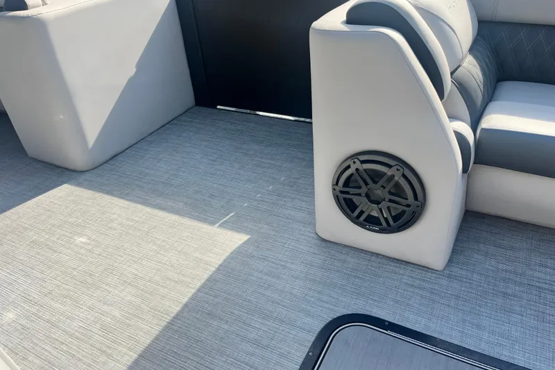 Slide: The Image of 2023 Harris Cruiser Sunliner 250 interior with speaker and cushioned seating. - 14