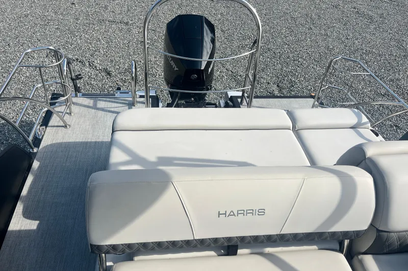 Slide: The Image of 2023 Harris Cruiser Sunliner 250 boat interior with cushioned seating and metal railings. - 15