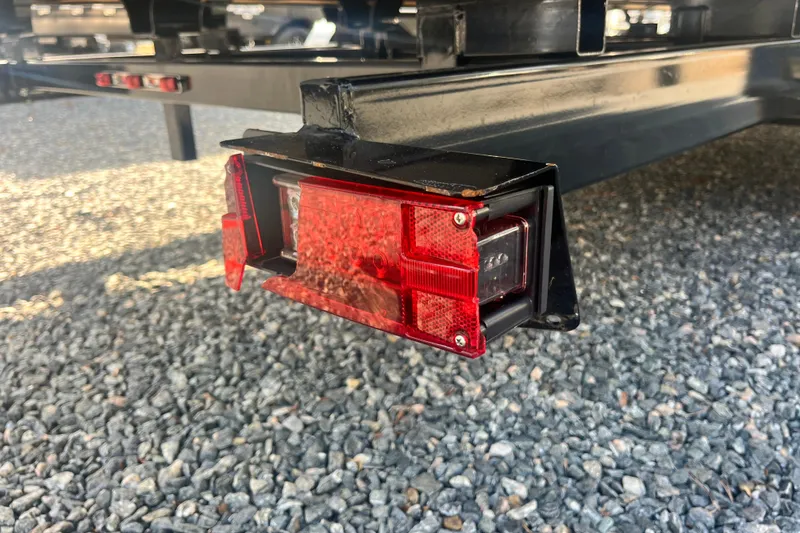 Slide: The Image of 2023 Harris Cruiser Sunliner 250 trailer light on gravel surface. - 17