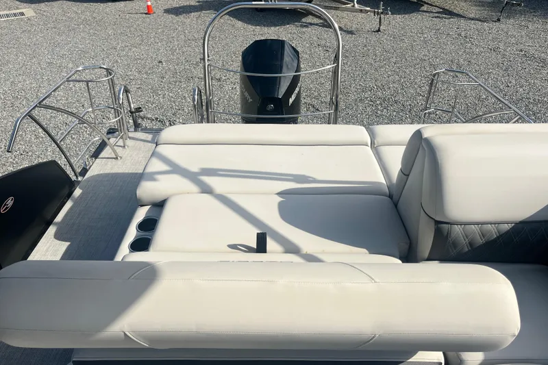Slide: The Image of 2023 Harris Cruiser Sunliner 250 boat with plush seating and sleek design. - 9