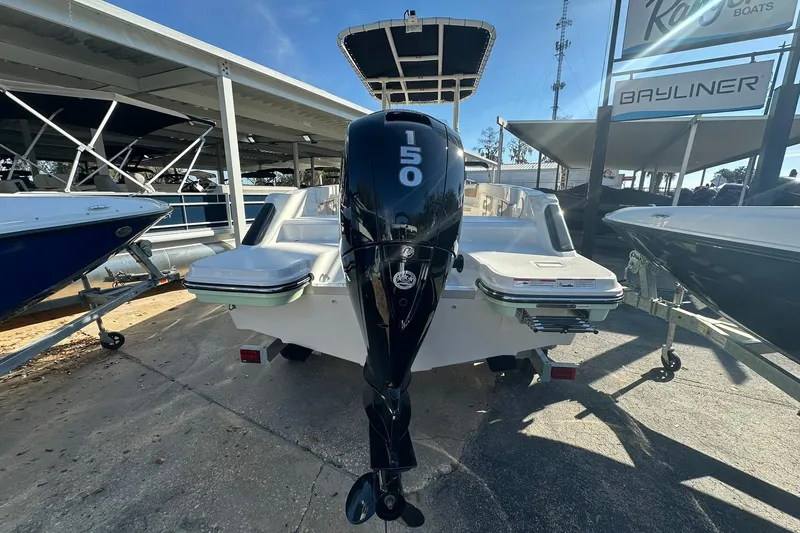 Slide: The Image of 2026 Bayliner Trophy T20CC boat with 150 horsepower outboard motor, displayed at a dealership. - 13