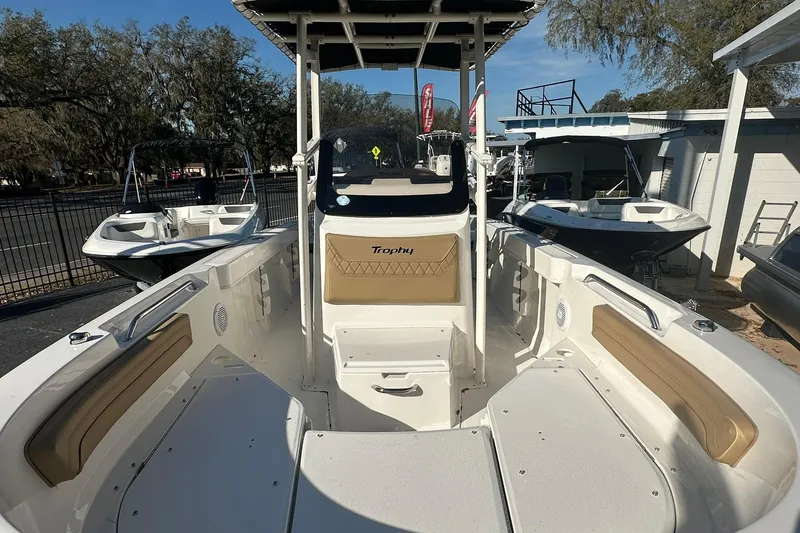 Slide: The Image of 2026 Bayliner Trophy T20CC boat interior with seating and console, displayed outdoors. - 4