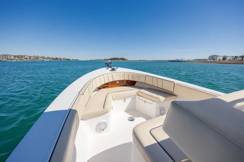 Slide: The Image of 2022 Vanquish Bristol Harbor 23 CC boat on calm blue water, sunny day. - 17