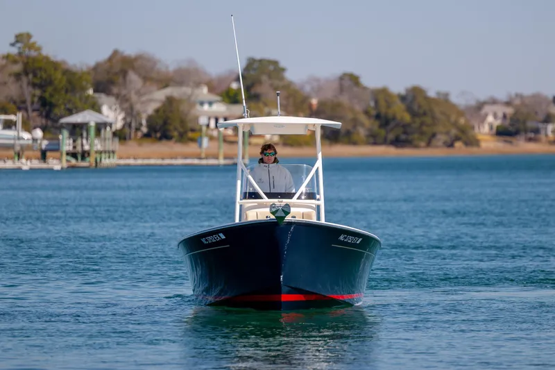 Slide: The Image of 2022 Vanquish Bristol Harbor 23 CC boat cruising on a calm waterway. - 2