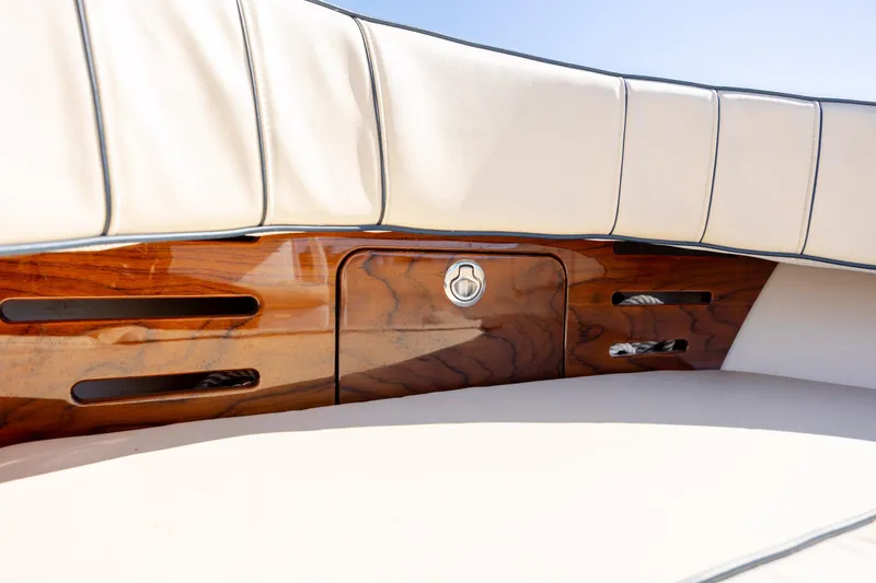 Slide: The Image of 2022 Vanquish Bristol Harbor 23 CC boat interior with elegant wood and cream upholstery. - 24