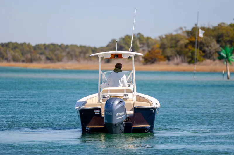 Slide: The Image of 2022 Vanquish Bristol Harbor 23 CC boat cruising on a serene lake. - 6