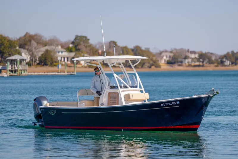 Slide: The Image of 2022 Vanquish Bristol Harbor 23 CC boat cruising on a calm lake. - 8