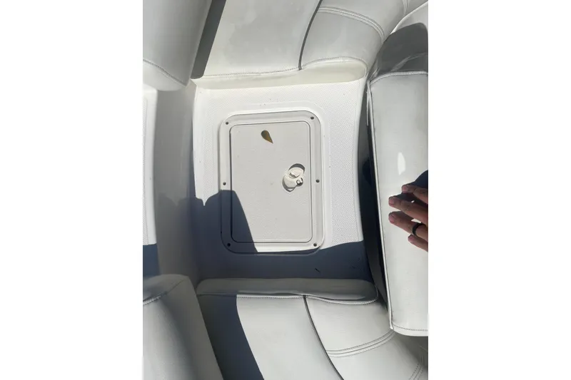 Slide: The Image of 2017 Godfey Hurricane SS 210 boat interior with storage compartment and white seating. - 10