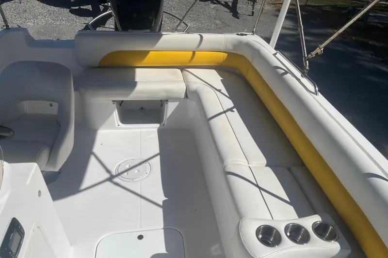 Slide: The Image of 2017 Godfey Hurricane SS 210 boat interior with white and yellow seating, cup holders. - 12