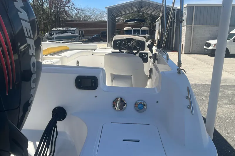 Slide: The Image of 2017 Godfey Hurricane SS 210 boat interior with Mercury engine, parked outdoors. - 18