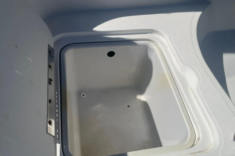 Slide: The Image of Storage compartment in 2017 Godfey Hurricane SS 210 boat, featuring a clean, white interior. - 21