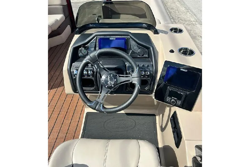 Slide: The Image of 2026 Bentley Pontoons 223 Elite Swingback DC dashboard with steering wheel and navigation screens. - 15