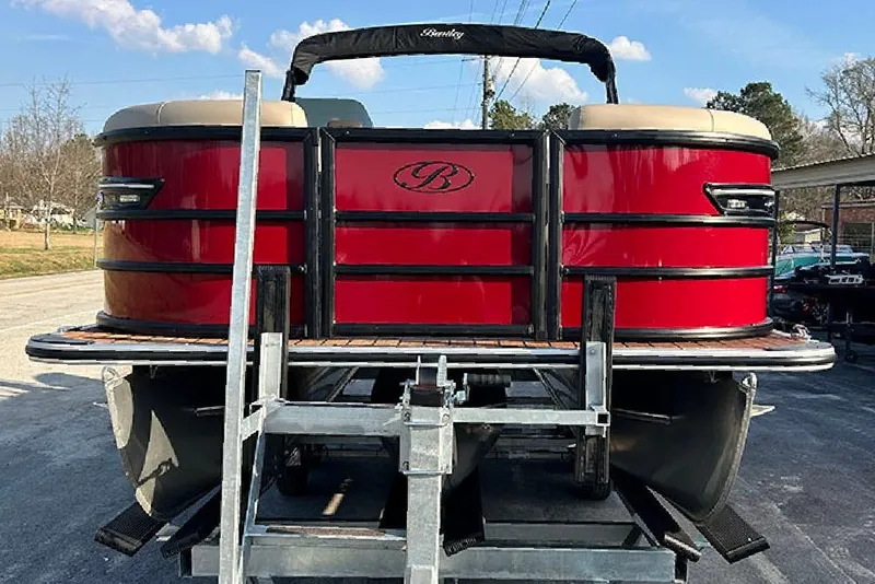 Slide: The Image of 2026 Bentley Pontoons 223 Elite Swingback DC, red exterior, on a trailer. - 2