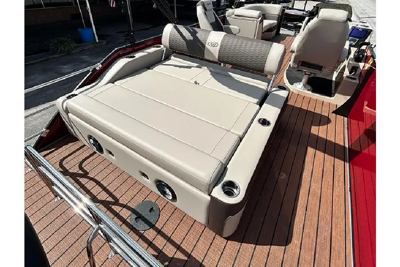 Slide: The Image of 2026 Bentley Pontoons 223 Elite Swingback DC with luxurious seating and wood-style deck. - 21