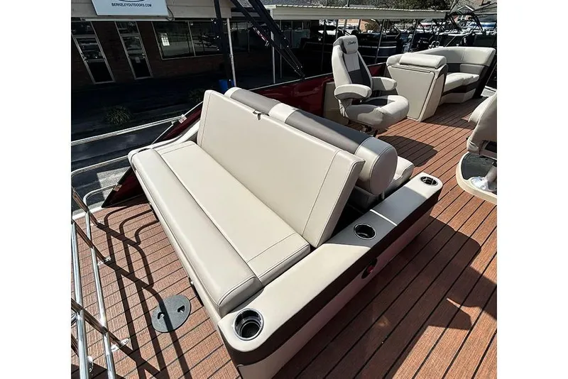 Slide: The Image of 2026 Bentley Pontoons 223 Elite Swingback DC with luxurious seating and wood-style flooring. - 23