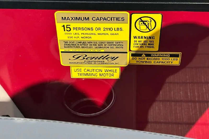 Slide: The Image of Safety labels on 2026 Bentley Pontoons 223 Elite Swingback DC, highlighting capacity and fuel warnings. - 25