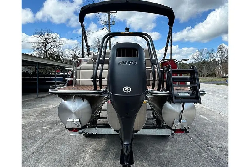 Slide: The Image of 2026 Bentley Pontoons 223 Elite Swingback DC with powerful outboard motor, rear view. - 3