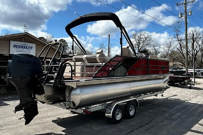 Slide: The Image of 2026 Bentley Pontoons 223 Elite Swingback DC on trailer, featuring Suzuki outboard motor. - 5