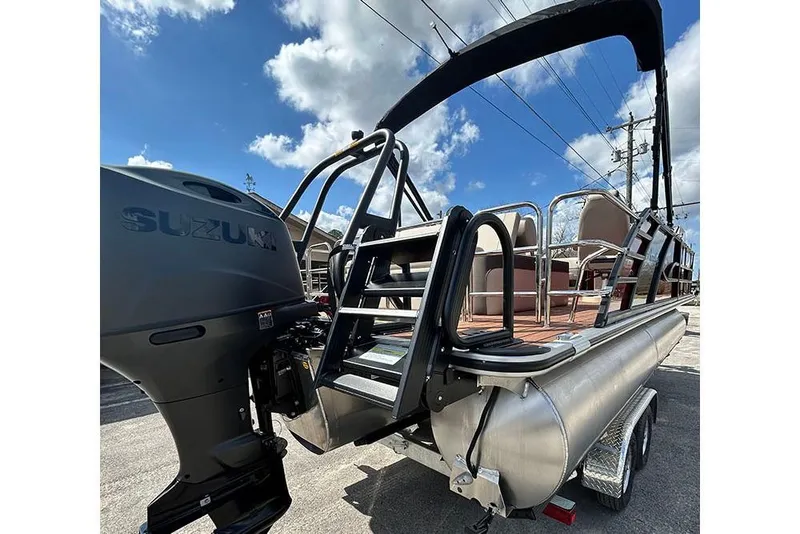 Slide: The Image of 2026 Bentley Pontoons 223 Elite Swingback DC with Suzuki engine, docked under blue sky. - 8