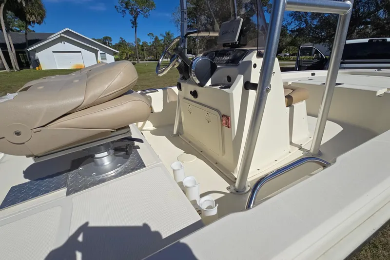 Slide: The Image of 2016 Scout 177 Sport boat interior with beige seating and steering console. - 5