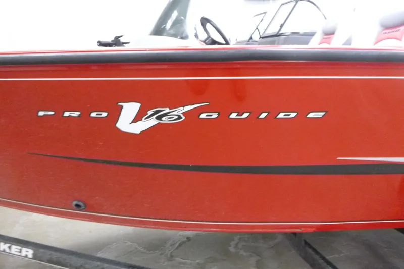 Slide: The Image of 2015 Tracker Pro Guide V-16 SC boat, red exterior with logo detail. - 17