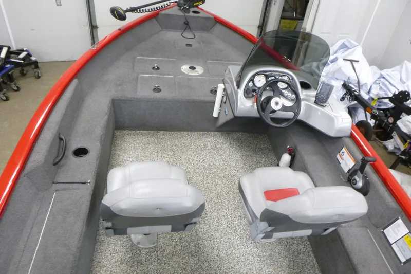 Slide: The Image of 2015 Tracker Pro Guide V-16 SC boat interior with steering console and seating. - 4