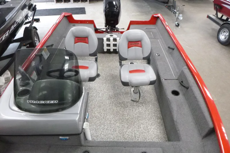 Slide: The Image of 2015 Tracker Pro Guide V-16 SC boat interior with seating and steering console. - 5