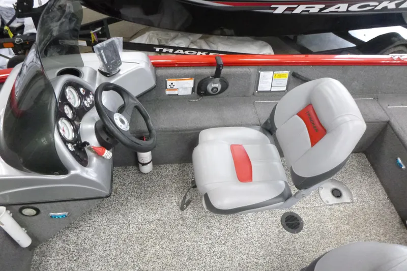 Slide: The Image of 2015 Tracker Pro Guide V-16 SC boat interior with steering wheel and seating. - 6
