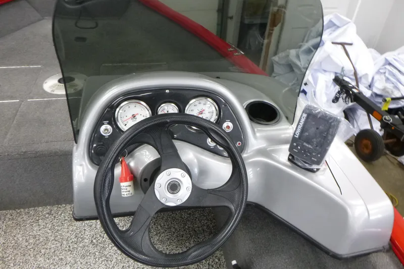 Slide: The Image of 2015 Tracker Pro Guide V-16 SC boat dashboard with steering wheel and gauges. - 7