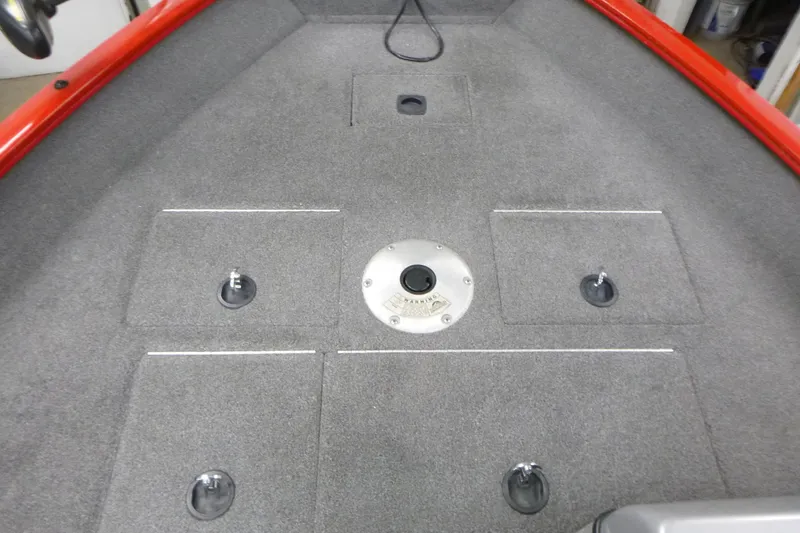 Slide: The Image of 2015 Tracker Pro Guide V-16 SC boat deck with storage compartments and red trim. - 9