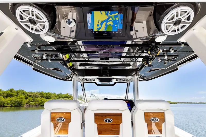 Slide: The Image of 2026 Pursuit S 388 Sport boat interior with fishing rods and navigation system. - 14