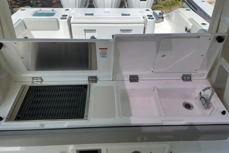 Slide: The Image of 2026 Pursuit S 388 Sport boat kitchen with grill and sink. - 21