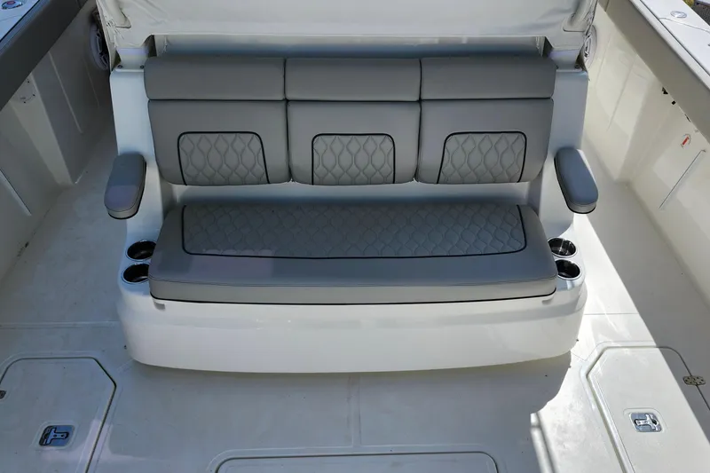 Slide: The Image of Luxury seating on 2026 Pursuit S 388 Sport boat, featuring quilted gray upholstery. - 22