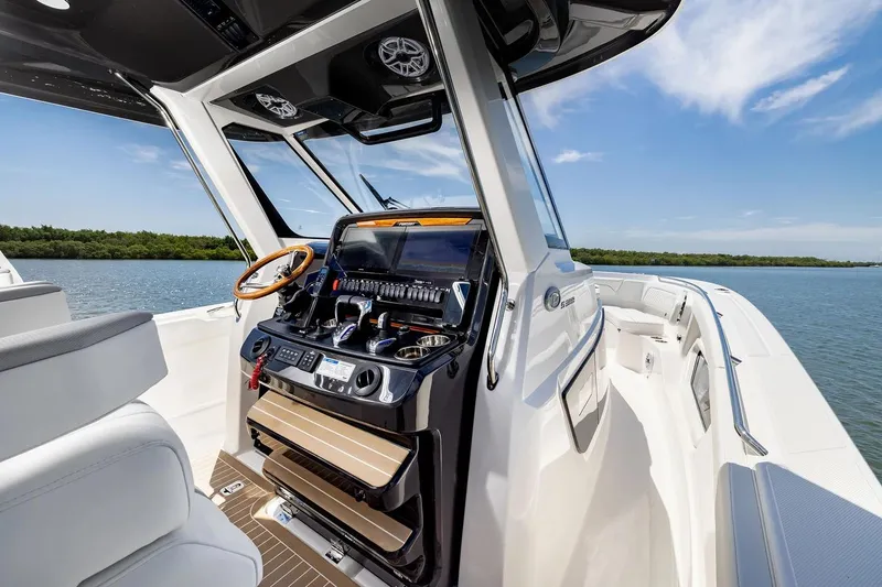 Slide: The Image of Manufacturer Provided Image: 2026 Pursuit S 388 Sport boat interior with modern helm, steering wheel, and water view. - 43