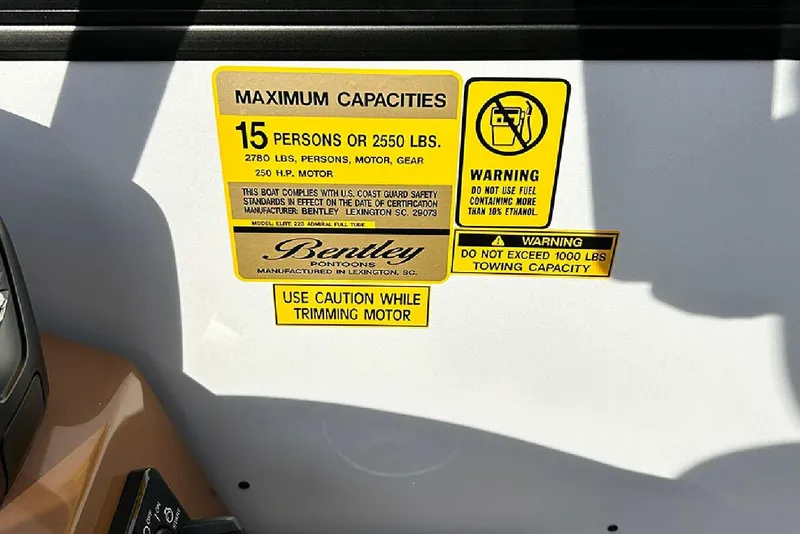Slide: The Image of 2026 Bentley Pontoons Elite 223 Admiral capacity and safety warning labels. - 15