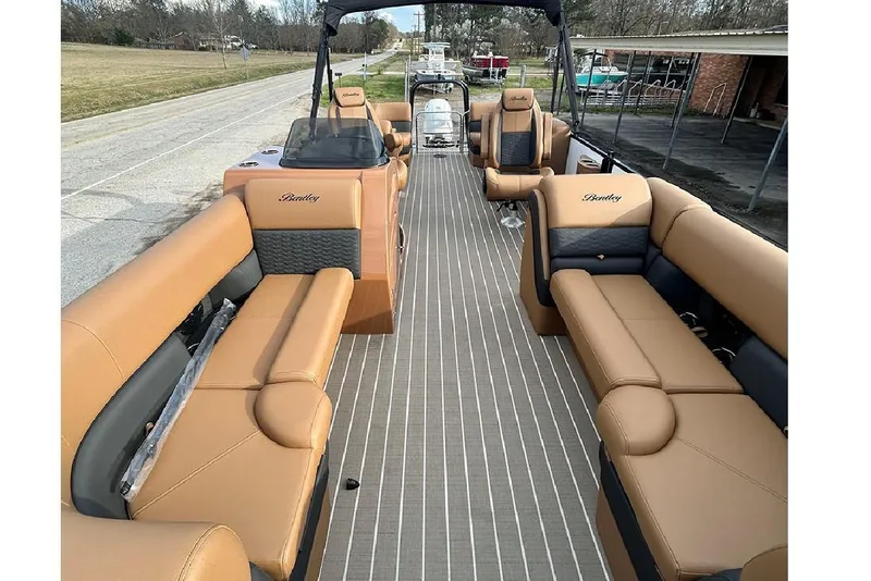 Slide: The Image of 2026 Bentley Pontoons Elite 223 Admiral with luxurious tan seating and spacious deck layout. - 7
