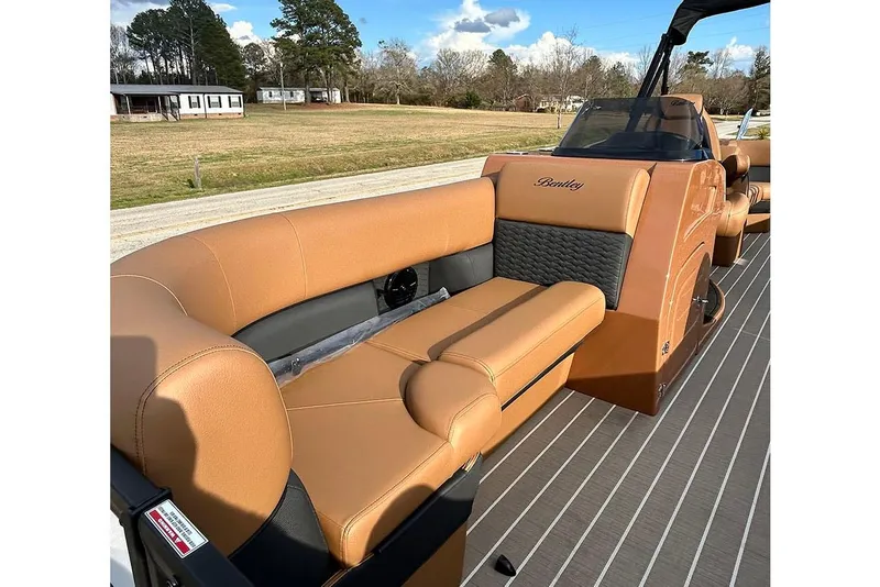 Slide: The Image of 2026 Bentley Pontoons Elite 223 Admiral with luxurious tan seating and sleek design. - 9