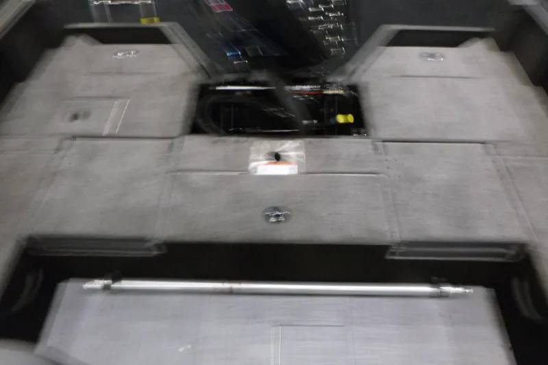 Slide: The Image of 2025 Alumacraft Competitor 195X Sport boat interior with storage compartments and seating area. - 13