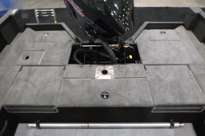 Slide: The Image of 2025 Alumacraft Competitor 195X Sport boat interior with engine and storage compartments. - 14