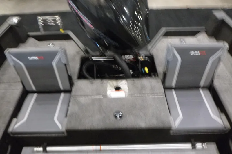 Slide: The Image of 2025 Alumacraft Competitor 195X Sport boat interior with gray seating and motor. - 15