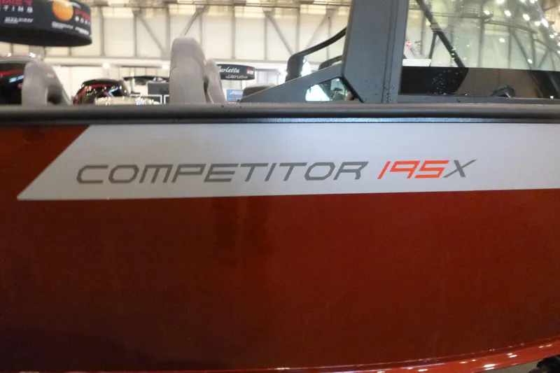 Slide: The Image of 2025 Alumacraft Competitor 195X Sport boat, close-up of model name on red exterior. - 18