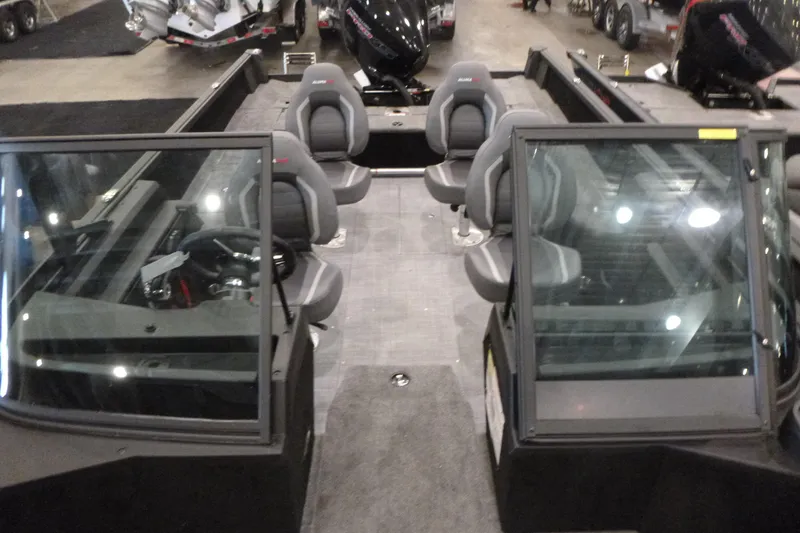 Slide: The Image of 2025 Alumacraft Competitor 195X Sport boat interior with seating and steering console. - 5