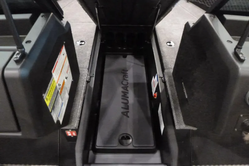 Slide: The Image of 2025 Alumacraft Competitor 195X Sport boat storage compartment, open and empty. - 7