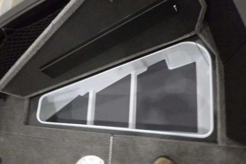 Slide: The Image of 2025 Alumacraft Competitor 195X Sport interior storage compartment detail. - 8