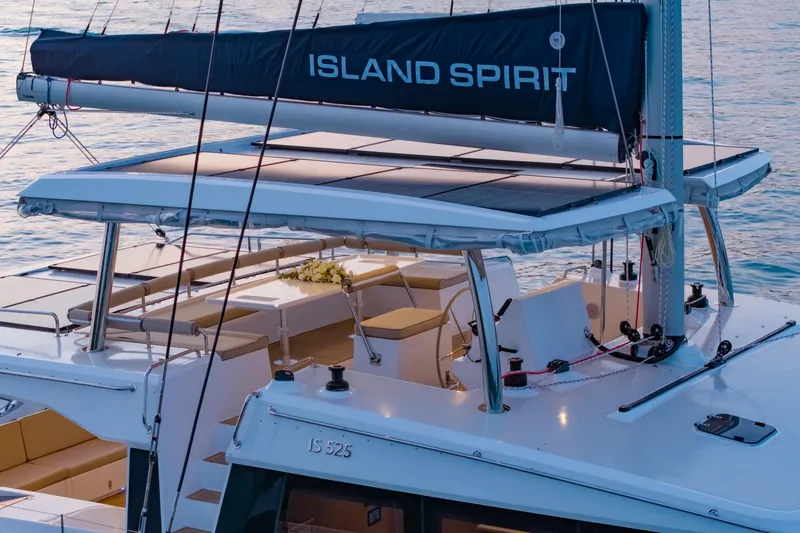 Slide: The Image of 2026 Island Spirit 525E yacht with sleek design and spacious deck on tranquil water. - 10